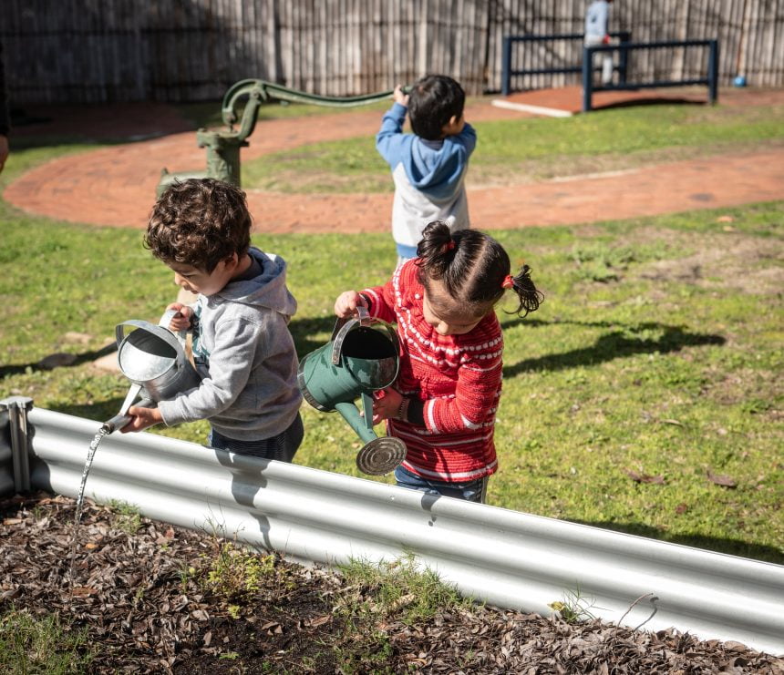 3 kids doing gardening activities outside