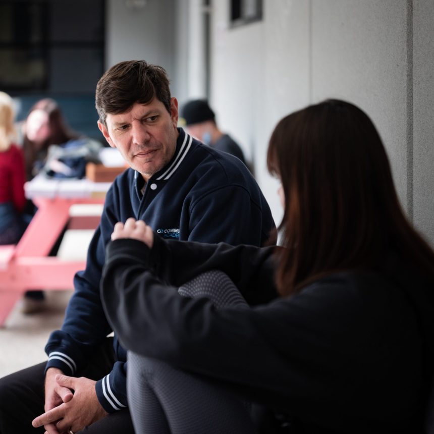 Man talking to teenager