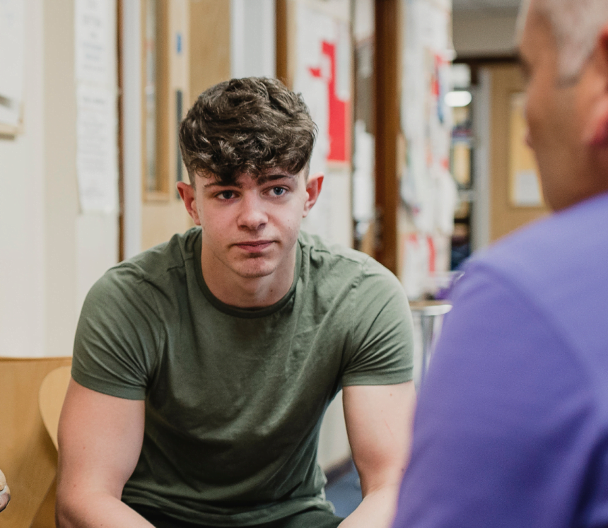 Young man talking to older man
