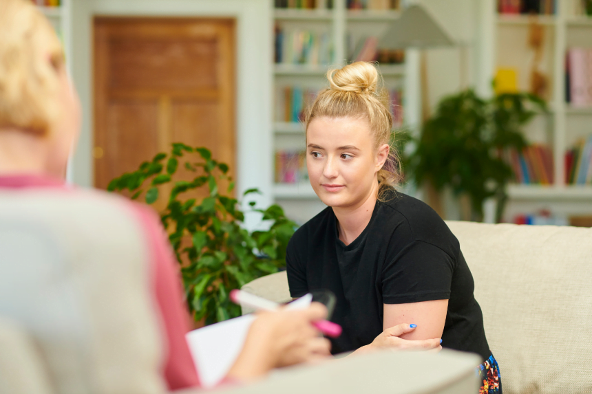 Young woman talking to counsellor