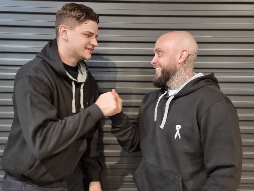 Two men in White Ribbon Australia hoodies