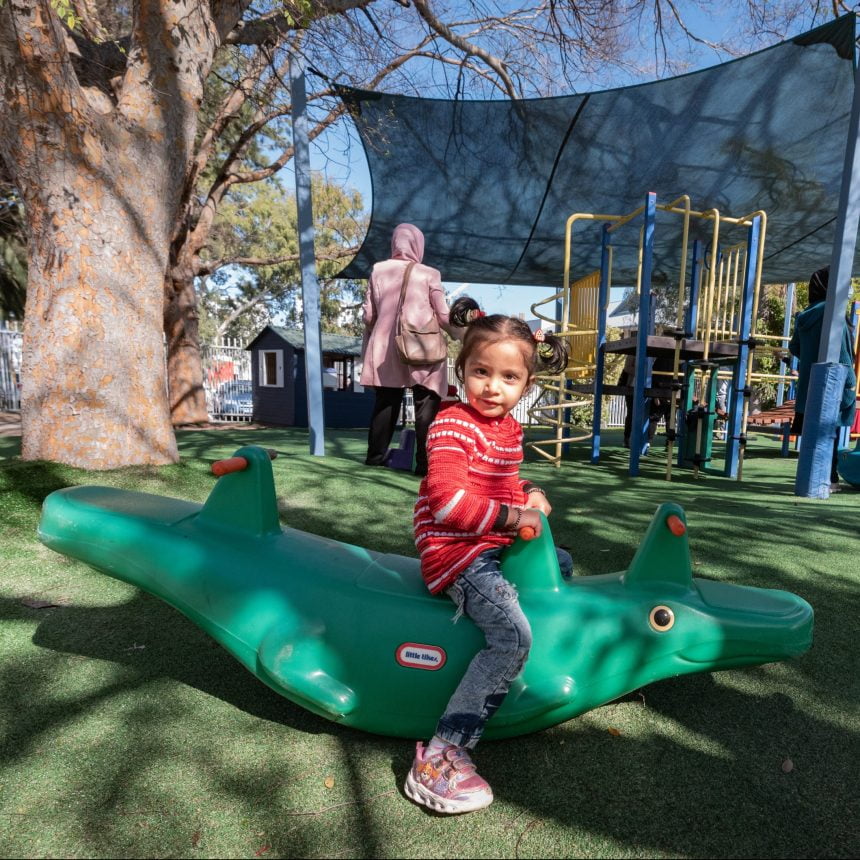 Child on toy in yard