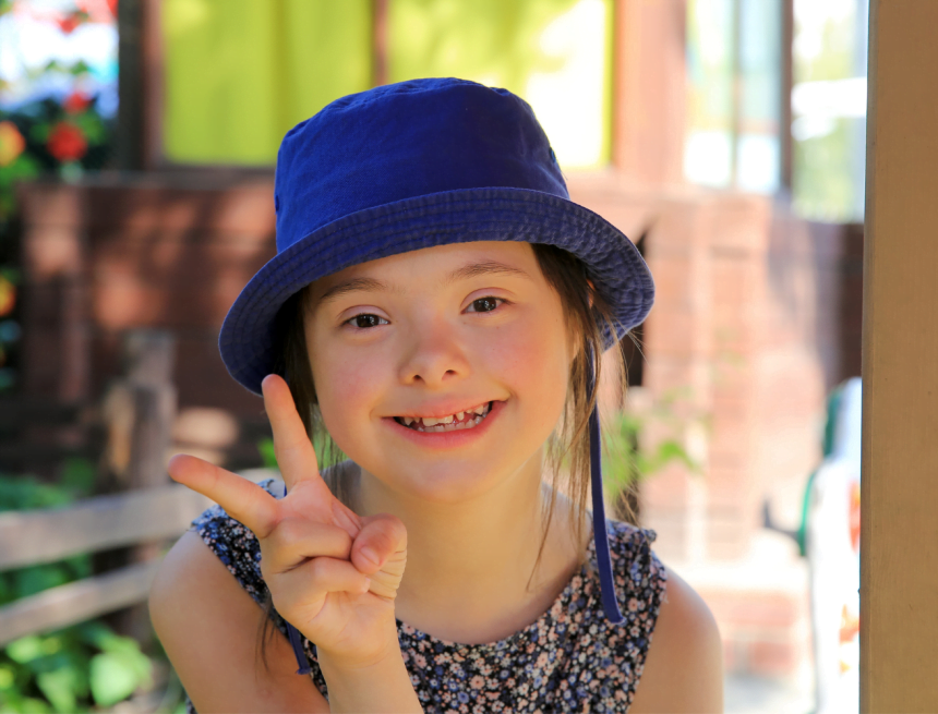 Girl with disability giving peace sign